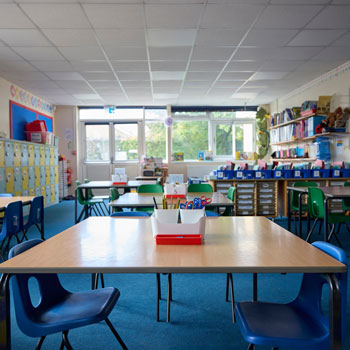 bright classroom with empty blue chairs